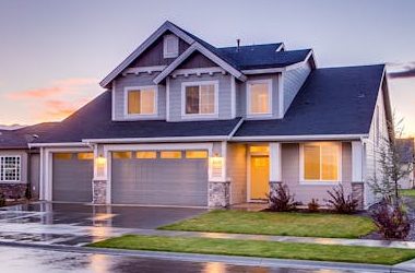 Elegant suburban home with driveway at sunset showcasing modern architecture.